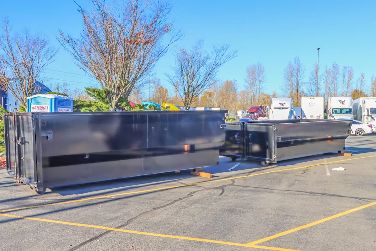 Professional dumpster rental service with roll-off container on residential driveway in Dodge City